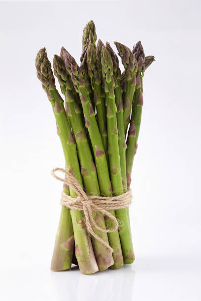 istock green asparagus sprouts over white background 990200454
