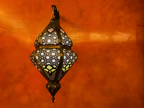exotic oriental lamp on the reddish wall…