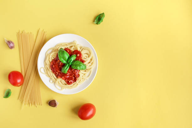 istock Spaghetti pasta bolognese on yellow 990201490