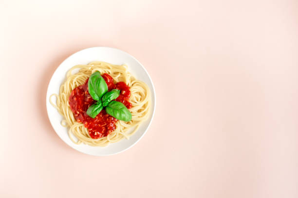 istock Spaghetti pasta bolognese on pink 990201516