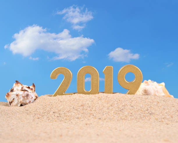 istock 2019 year golden figures on a beach sand 990201522
