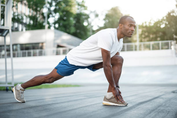 istock Focused male athlete workouting on stadium 990204326