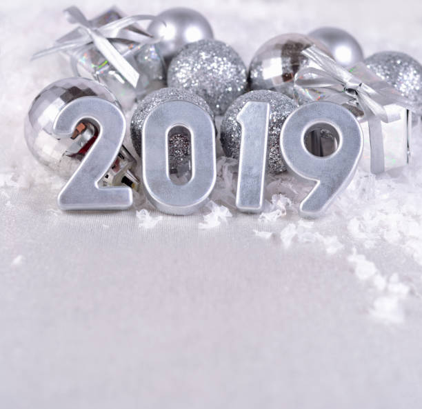 istock 2019 year silver figures and silvery Christmas decorations 990204432