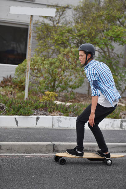 istock Young man on electric skateboard about town 990218680