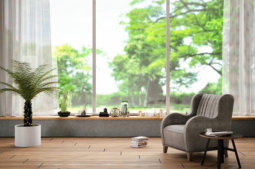 Interior with armchair, coffee table and nature view
