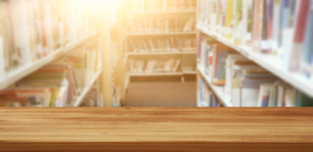 empty wooden table in library. education and learning concept. empty wooden table in library. education and learning concept opportunity dictionary definition stock pictures, royalty-free photos & images
