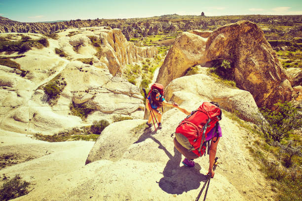 istock A helping hand, tourists helping each other. 990253834