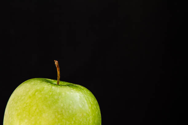 istock top of green fresh Apple on black background 990263404