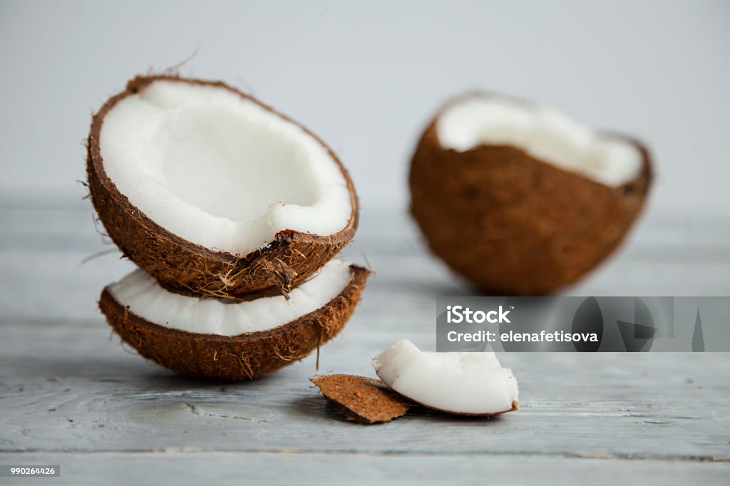 Fresh organic coconut on rustic wooden background broken fresh organic coconut on rustic wooden grey background Coconut Stock Photo