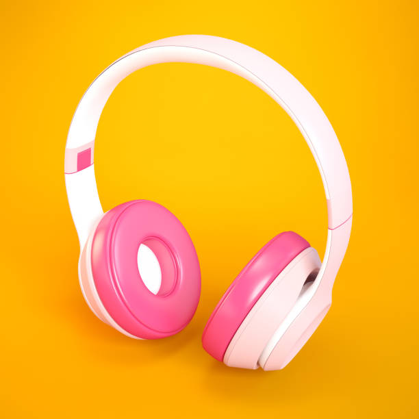 Pink and white headphones on orange background
