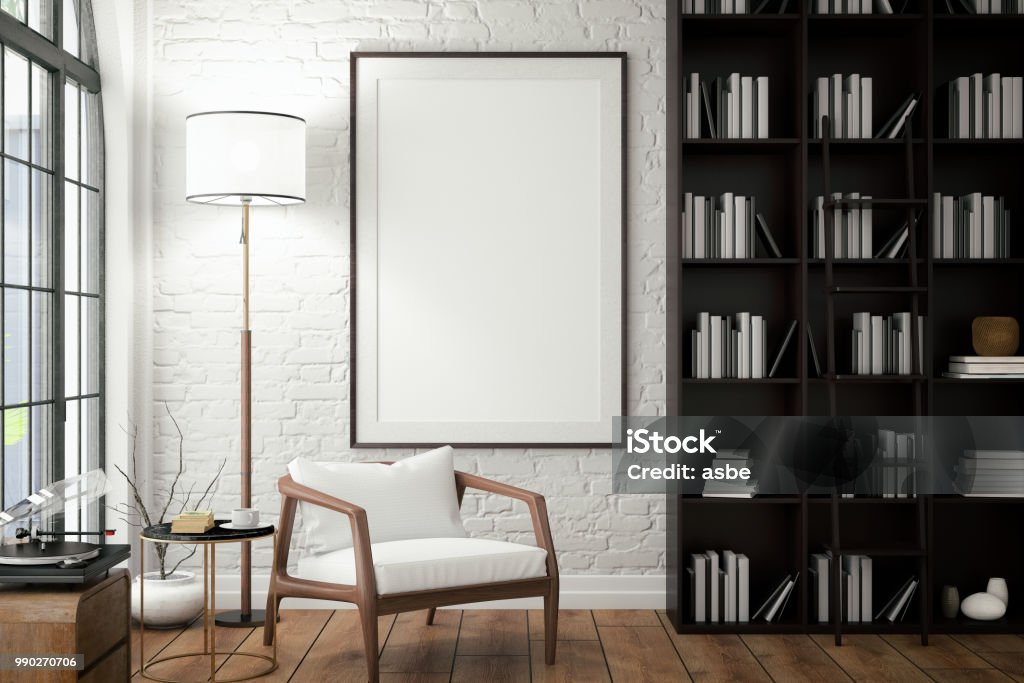 Empty Frame on Living Rooms Wall with Library Vertical picture frame in living room Picture Frame Stock Photo