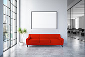 Waiting Room with Empty Frame and Red Sofa