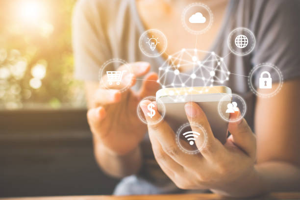 istock Asian woman hand using smartphone with icon technology artificial intelligence (AI) and internet of things (IOT) 990285294