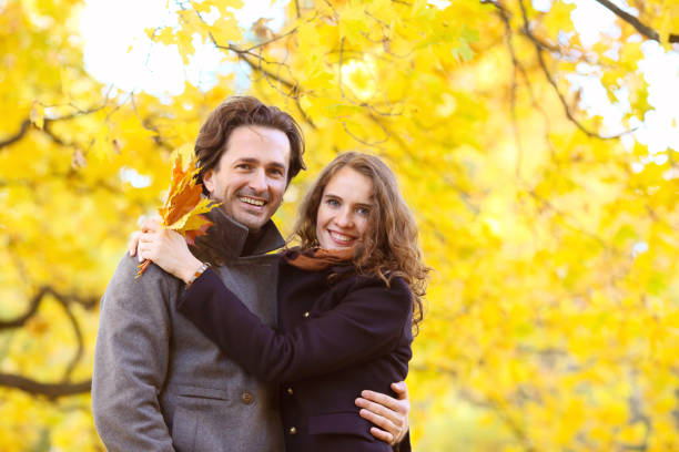 istock Smiling couple hugging in autumn park 990285758