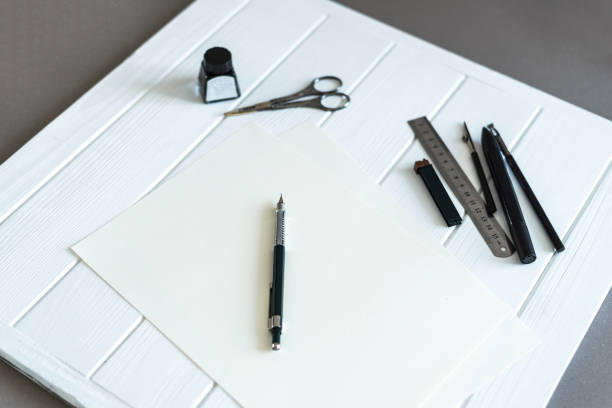 istock Design studio. Designer's attributes on the table: pen, penci, scissors ets. 990288534