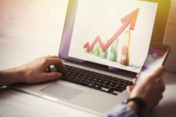 istock Young businessman using his laptop, close up. Business workplace and business objects.Freelancer work at home 990295622