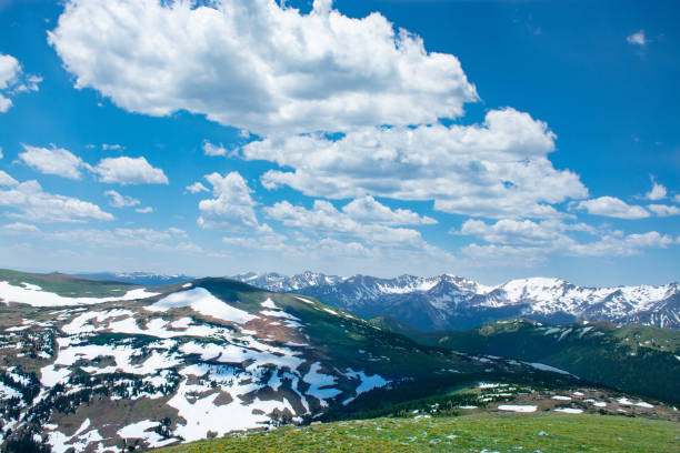 istock Beautiful Colorado spring landscape with green meadows and snow covered mountains. 990300748