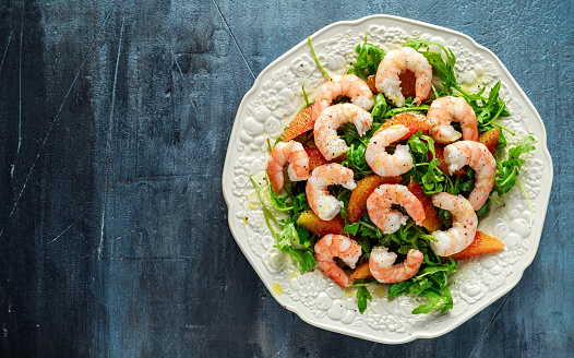 Asian style shrimp salad with wild rocket and blood orange served with lemon wedges and balsamic vinegar drizzle.