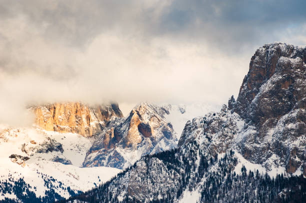 istock Mountain peaks in the clouds at sunset, Dolomites, Italy 990304798