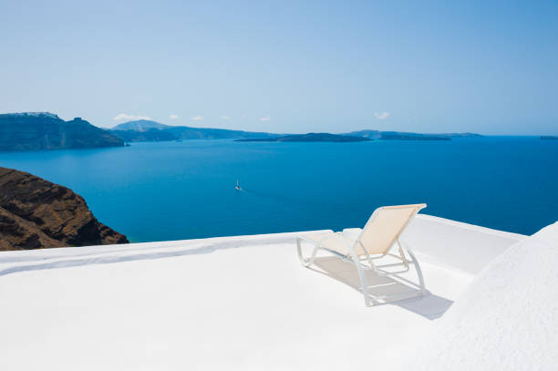 istock Chaise lounge on the terrace, Santorini island, Greece 990304828