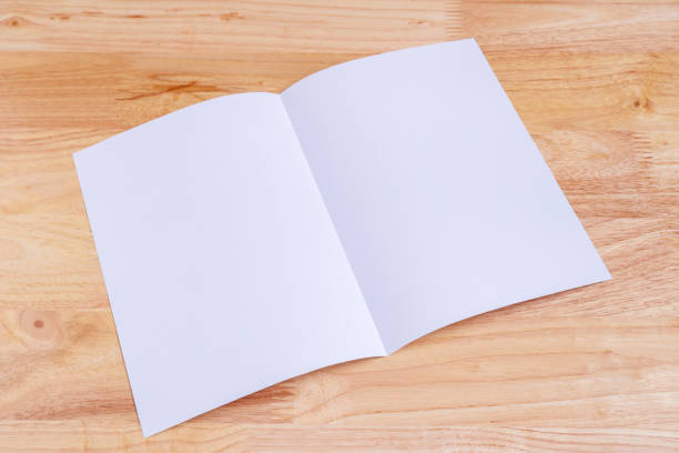 istock Recycled paper book on wooden background 990305164