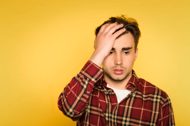 istock regret remorse dismay man emotion clutch head 990311558