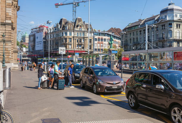 People and taxi cars in front of the Zurich main railway station Zurich, Switzerland - June 30, 2018: people and taxi cars in front of the Zurich main railway station. Zurich main railway station is the largest and buisiest railway station in Switzerland. zurich train station stock pictures, royalty-free photos & images