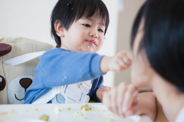istock A Little baby eating her dinner and making a mess 990326692