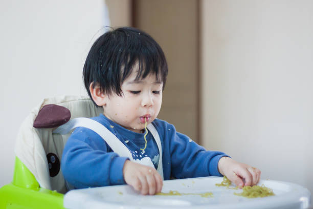 istock A Little baby eating her dinner and making a mess 990326710