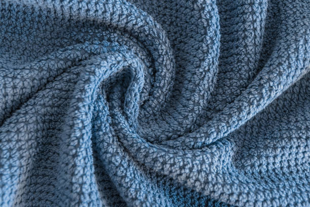 istock Close up view on blue cotton towel. Spa and wellness thing. Selective focus 990339964