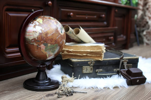 istock composition on a wooden floor vintage globe with old leather sui 990346472