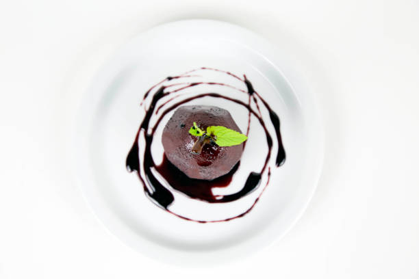 istock Pears poached with red wine syrup on white plate 990347176