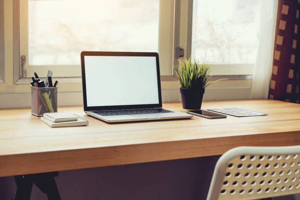 istock Laptop on table in office room background, for graphics display montage. Take your screen to put on advertising. 990347802