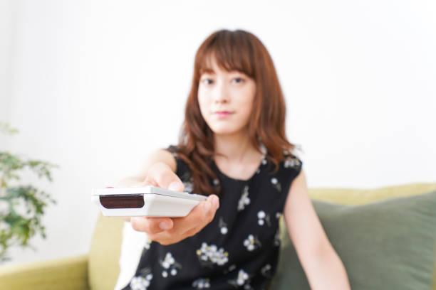istock Woman watching TV at home 990347946