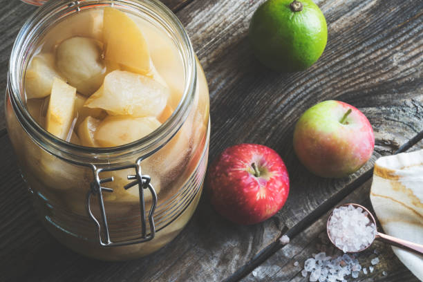 istock Apple cider vinegar in hinged lid jar on rustic background 990352520
