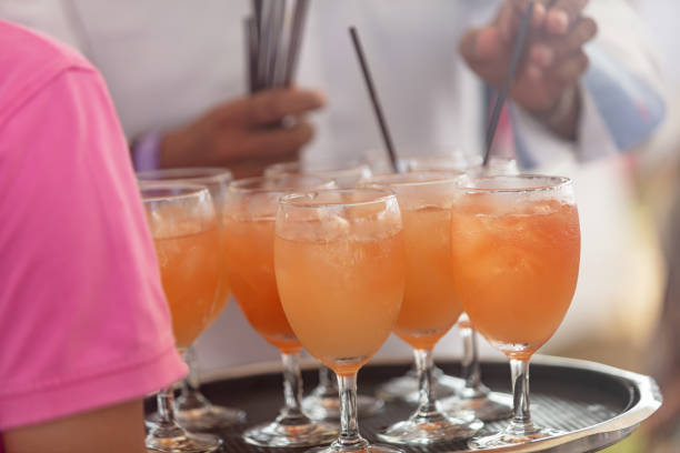 Wait staff serving cocktails at outdoor party