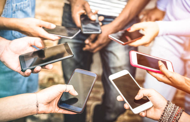 istock Friends group having addicted fun together using smartphones - Hands detail sharing content on social network with mobile smart phone - Technology concept with people millennials online with cellphone 990360552