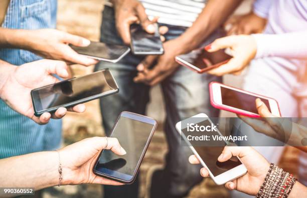 Friends Group Having Addicted Fun Together Using Smartphones Hands Detail Sharing Content On Social Network With Mobile Smart Phone Technology Concept With People Millennials Online With Cellphone Stock Photo - Download Image Now