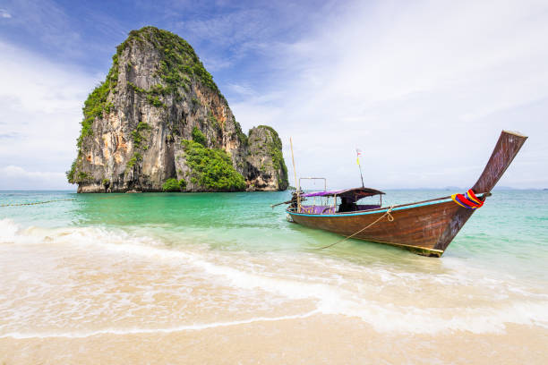 istock Beautiful seascape with limestone rock and longtail boat 990366440