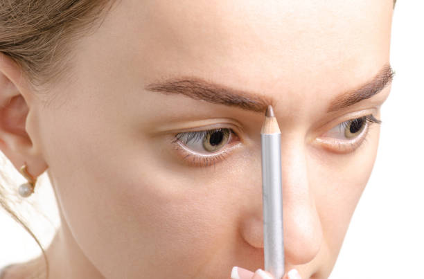 istock Female eyebrow shape brown eye eyebrow pencil 990375226