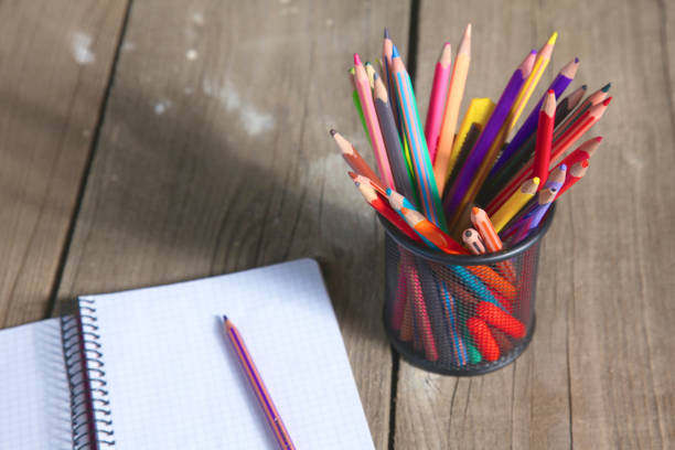 istock book and pencil on old wooden table 990393434