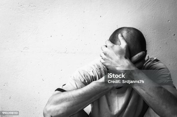 Homeless Man Drug And Alcohol Addict Sitting Alone And Depressed On The Street Feeling Anxious And Lonely Social Documentary Concept Black And White Stock Photo - Download Image Now