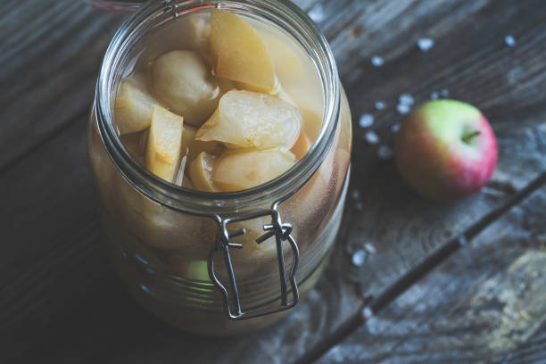 istock Apple cider vinegar in hinged lid jar on rustic background 990428416