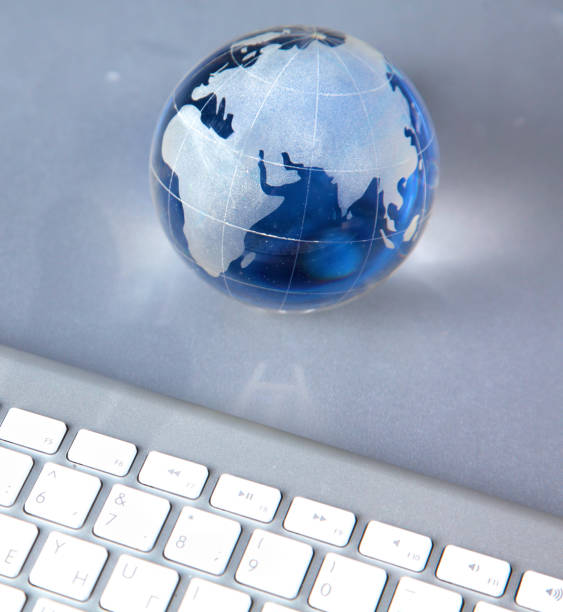 istock Cristal globe of the Earth on a Computer 990437762
