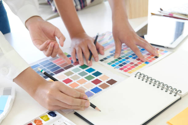 istock Close up Artist discussion meeting with colour planning project. 990442052