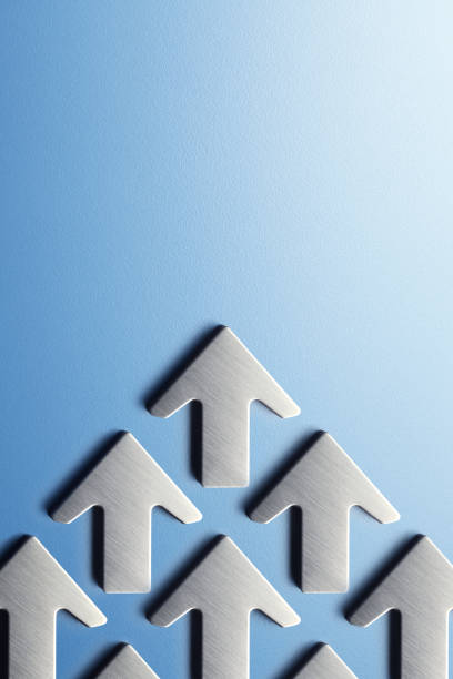A group of silver arrows point upward on a blue background.