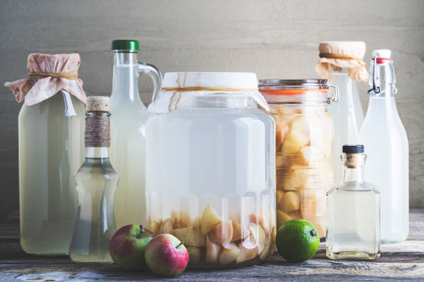 istock Bottles of apple cider vinegar on rustic background 990447314
