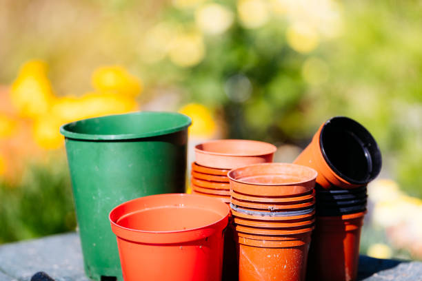 Stacks of empty plant pots in a greenhouse