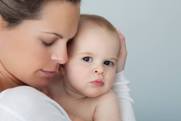 istock Mother Giving Affection to her Baby Boy 990451336