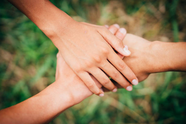 istock Hand holding hand show helping on blurred background 990454296